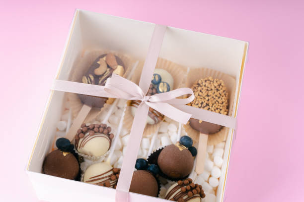 istock popsicle shaped cake pops and marshmallows in white box on pink background 1485667080
