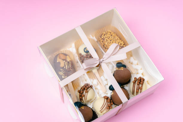 istock popsicle shaped cake pops and marshmallows in white box on pink background 1485667122