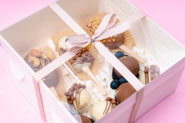 istock popsicle shaped cake pops and marshmallows in white box on pink background 1485667125
