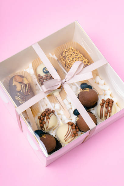istock popsicle shaped cake pops and marshmallows in white box on pink background 1485667140
