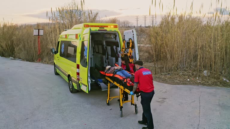 Emergency services putting injured man in ambulance