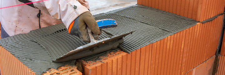 bricklayer at work at new house in construction