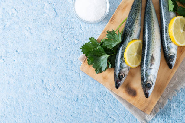 istock Raw mackerel fish salt around on blue background 1485676232