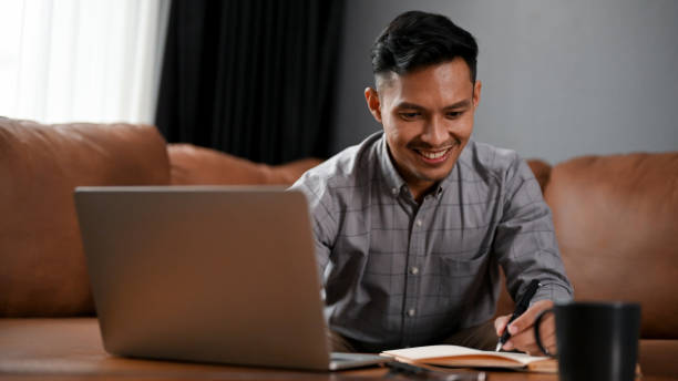 istock Happy millennial Asian businessman remote working at home 1485676736