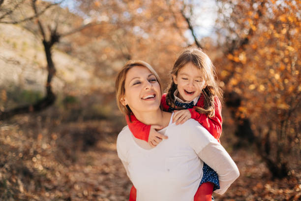 istock Mother and child having fun in autumn park 1485678072