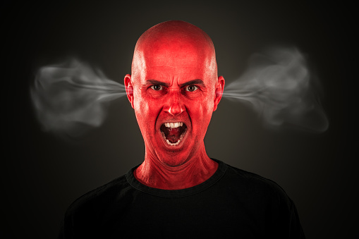 portrait angry mid adult man with bald head completly red colored shouting, smoke coming out of his ears