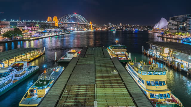 4K Footage Night Time Lapse of Circular Quay can see Sydney Harbor Bridge, Opera House, Lunar park, cruise ship and passenger ship leaving port