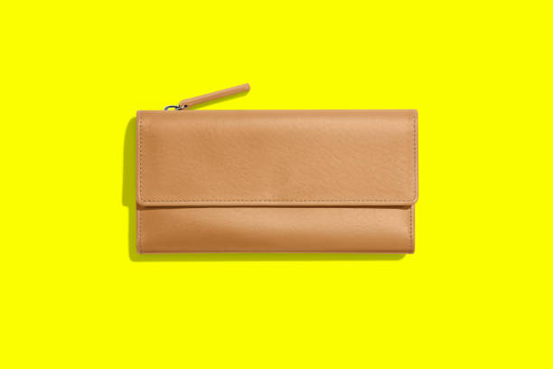 istock Fashionable leather women's wallet on a yellow background. added copy space for text. 1485681352