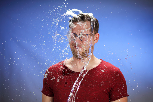 Caucasian man after splash of water for sides.