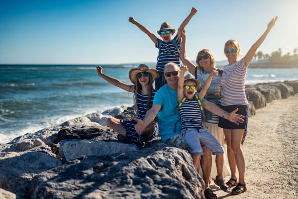 Multi-generation family enjoying sunny summer day by the sea. Mother and kids enjoying a walk on the beach. They are standing on the big rocks of the beach groyne or breakwater. Sunny summer day in Costa del Sol, Spain.
Nikon D810 family beach vacations travel stock pictures, royalty-free photos & images