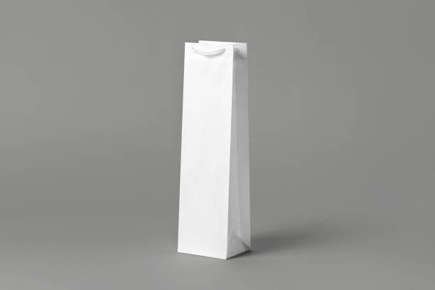 istock Blank tall white wine bottle bag mockup set, isolated, 3d rendering. Empty carry handbag for wine or vodka mock up. Clear paper packaging fit for store branding. 1485686583
