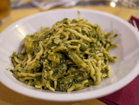 Trofie al Pesto, italian pasta with pesto sauce and green beans. Speciality of Genoa, Italia.