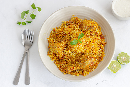 Chicken Biryani with Yogurt, Lemon and Mint Leaves Directly Above Photo