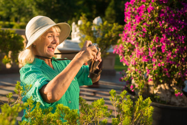 istock Senior woman holding camera. 1485691273