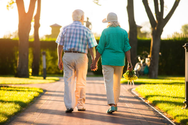 istock Couple walking on park alley. 1485693486
