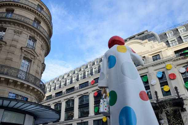 Paris, France - March 18, 2023:  Sculpture of the Japanese artist Yayoi Kusama in front of Louis Vuitton Headquarters repainting the facade of the building with colored dots in Paris, France.