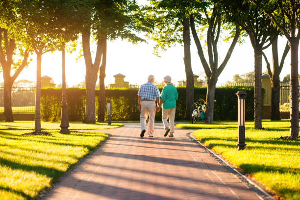 Senior woman and caregiver go walking outdoors