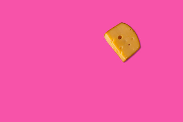 Cheese piece in Creative conceptual top view flat lay composition with copy space isolated on pink background in minimal style