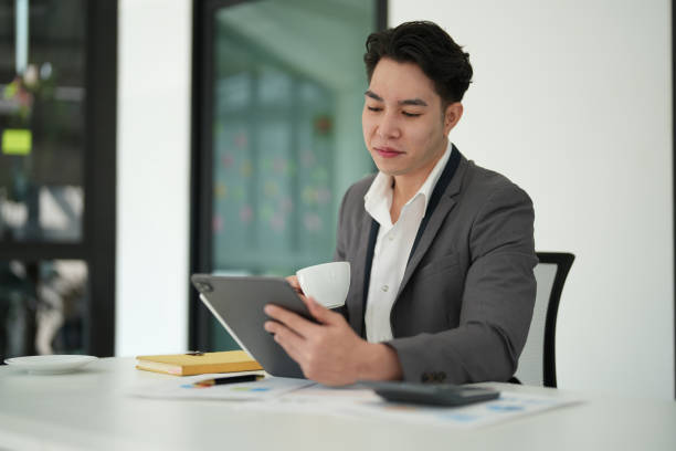business owner or Asian female marketers are using tablet computer in office work