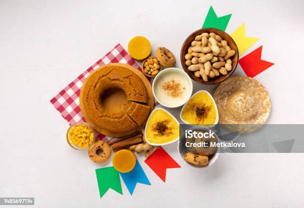 Festa Junina Summer Festival Carnival Concept Brazilian Straw Hat Popcorn Peanuts And Corn Cake On White Wooden Background Stock Photo - Download Image Now