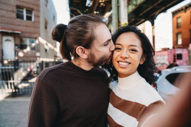istock An hipster couple is taking a selfie in Bushwick, Brooklyn 1485704155