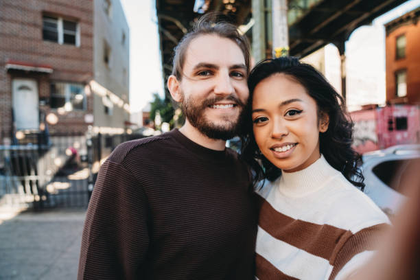 istock An hipster couple is taking a selfie in Bushwick, Brooklyn 1485704156