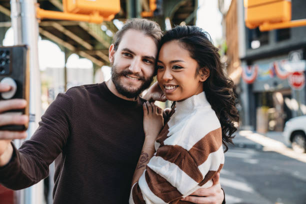 istock An hipster couple is taking a selfie in Bushwick, Brooklyn 1485704163