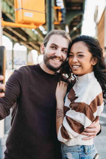 istock An hipster couple is taking a selfie in Bushwick, Brooklyn 1485704176
