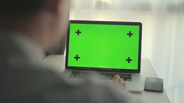 Dolly shot of businessman using chroma key computer laptop at office,No people