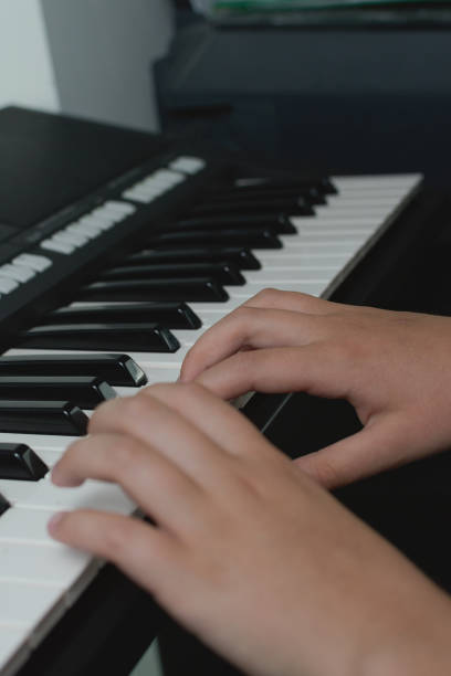 istock Piano exercises. Two hands playing lessons. Synthesizer keyboard close-up. 1485705071