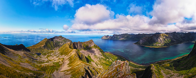 Aerial panorama of the Husfjellet Mountain on Senja Island in northern Norway with views over surrounding fjords and mountains.