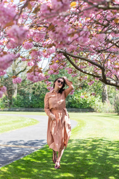istock Beautiful woman under sakura tree 1485711126