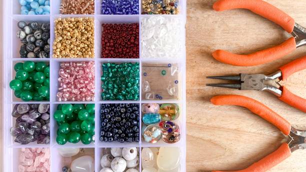 istock Storage box of colourful beads with pliers equipment 1485711726