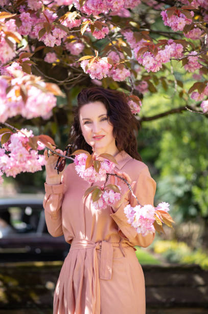 istock Beautiful woman under sakura tree 1485711738