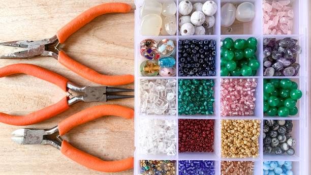istock Storage box of colourful beads with pliers tools 1485711850