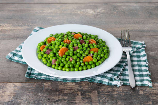 istock Green peas with serrano ham and carrot 1485712291