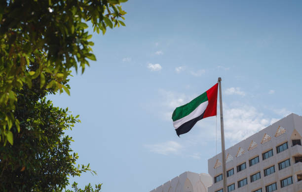 istock United Arab Emirates flag flying against sky. 1485712702
