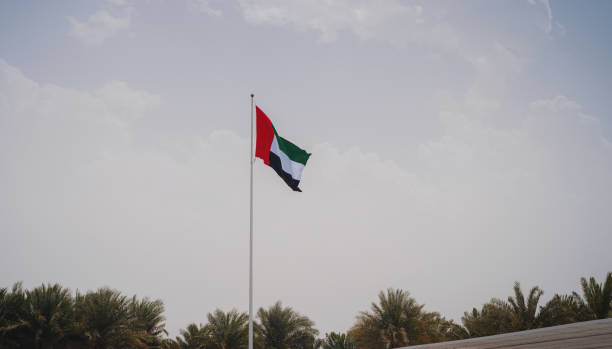 istock United Arab Emirates flag flying against sky. 1485712821