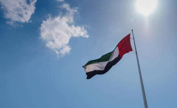 istock United Arab Emirates flag flying against sky. 1485712936
