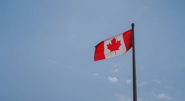 istock Flag of Canada flying against a blue sky. 1485713462