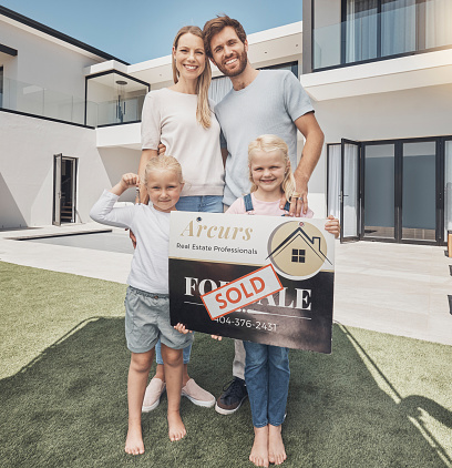 Real estate, sign and portrait of family with keys moving advertisement, property and homeowner. Happy, showing and parents with children, board and relocation after buying a new home from real estate agent