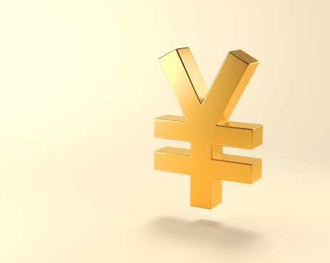 Metallic Gold color Japanese Yen symbol standing on light yellow background with copy space. Digitaly generated image.