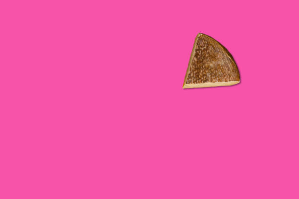 istock Cheese piece in Creative conceptual top view flat lay composition with copy space isolated on pink background in minimal style 1485727834