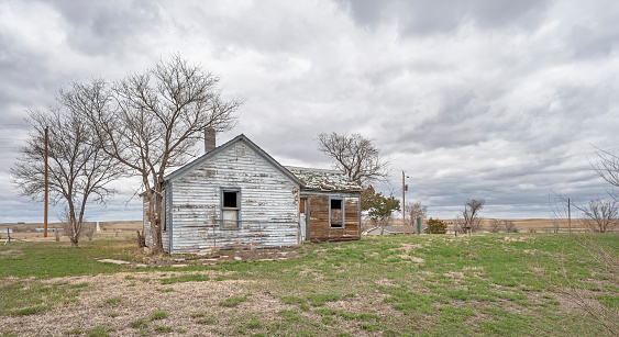 Quinn, South Dakota, USA - April 15, 2023:  Exterior view of an abandoned wooden house within the village