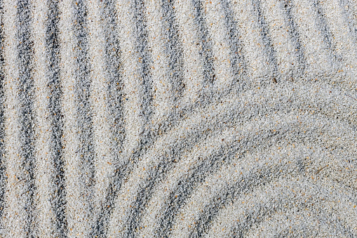 Zen drawing in the sand. the concept of harmony, balance and meditation, spa, relaxation. abstract texture for background.