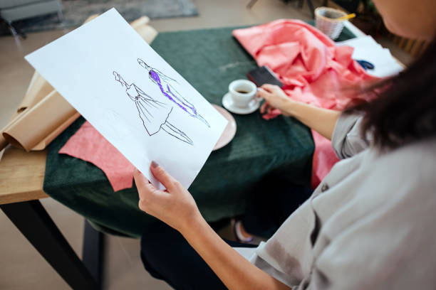 istock Female tailor looks at a sketch 1485730114