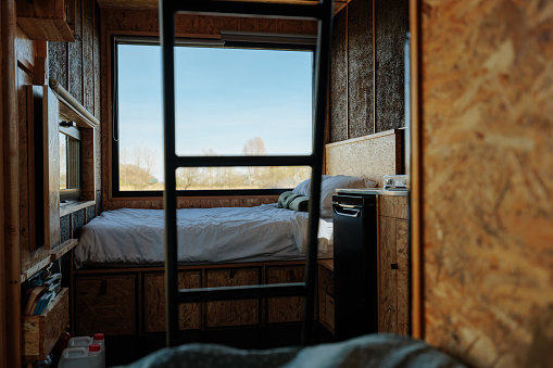 An interior space of a small campground cabin with no people.