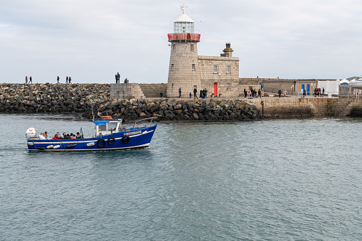 Chrsitmas Eve - Ireland's Eye Ferry passing the Lighthouse on the East Pier entering the Harbour, Howth, Dublin, Ireland