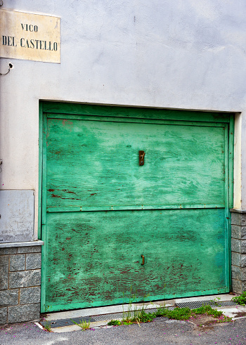characteristic green wooden door in millesimo savona italy