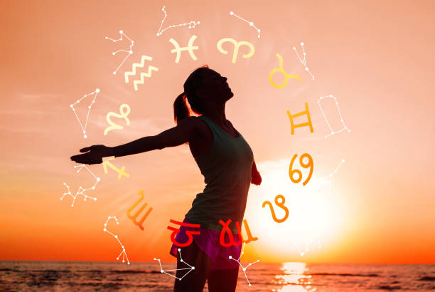 Concept of astrology and horoscope, person inside a zodiac sign wheel stock photo
